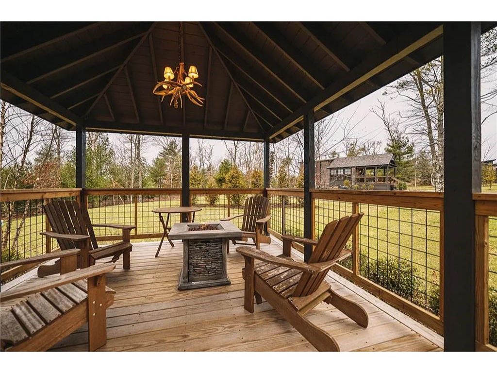 image A spacious, covered patio with outdoor seating—perfect for al fresco dining while enjoying nature views.