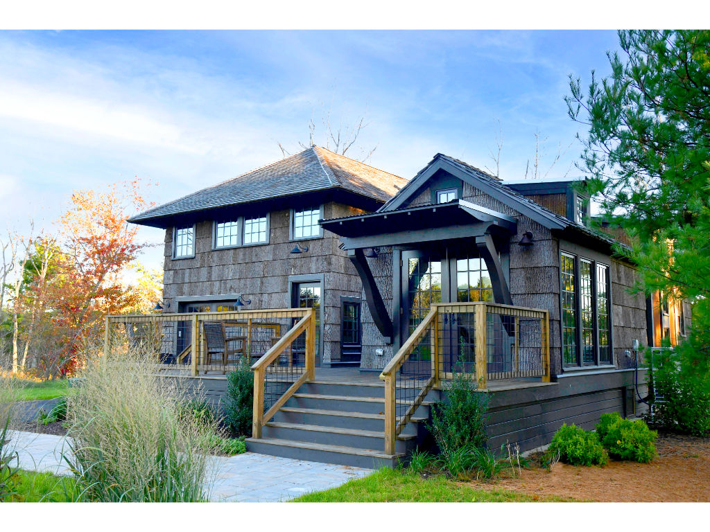 image Experience ultimate comfort in this charming home featuring a fully-equipped studio and a welcoming front porch.