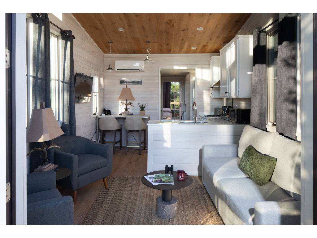 image Relax in the open living area, boasting contemporary decor and a seamless blend of indoor and outdoor living spaces.