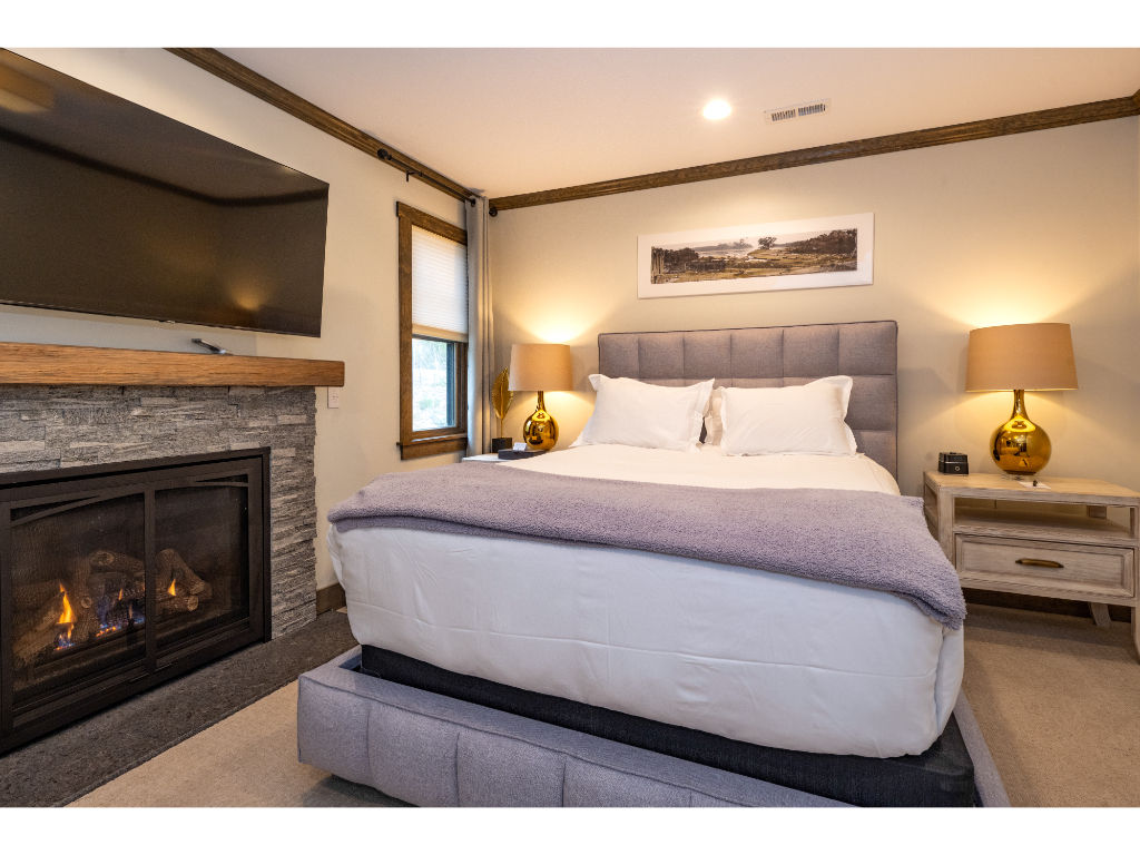 image Elegant bedroom with a cozy fireplace, plush bedding, and sophisticated decor for a serene retreat.