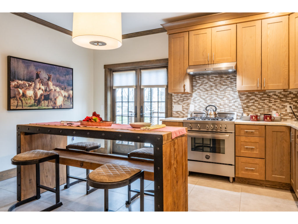 image Gourmet kitchen equipped with modern appliances, granite countertops, and a stylish breakfast bar, perfect for culinary creations.