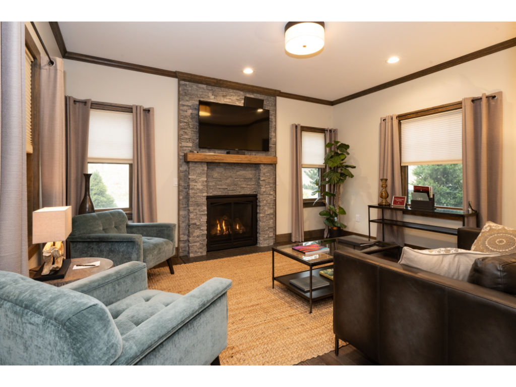 image Inviting living room with plush seating, a cozy fireplace, and elegant decor, creating a warm and welcoming atmosphere.