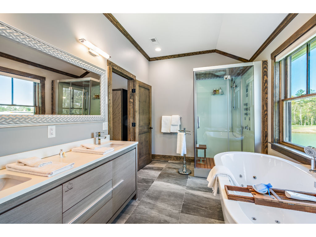 image Luxurious bathroom featuring a double vanity, glass-enclosed shower, and elegant fixtures, providing a spa-like experience.