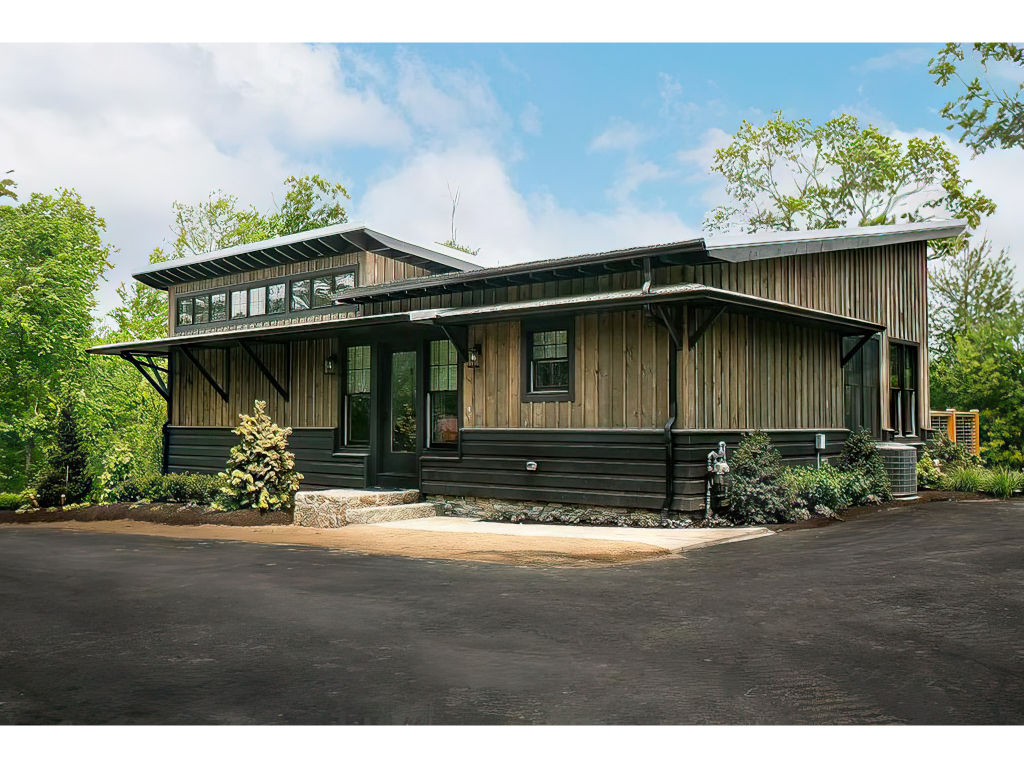 image Laurel Ridge Modern Cabin - A contemporary retreat nestled in lush greenery, providing a tranquil escape with stylish comfort.