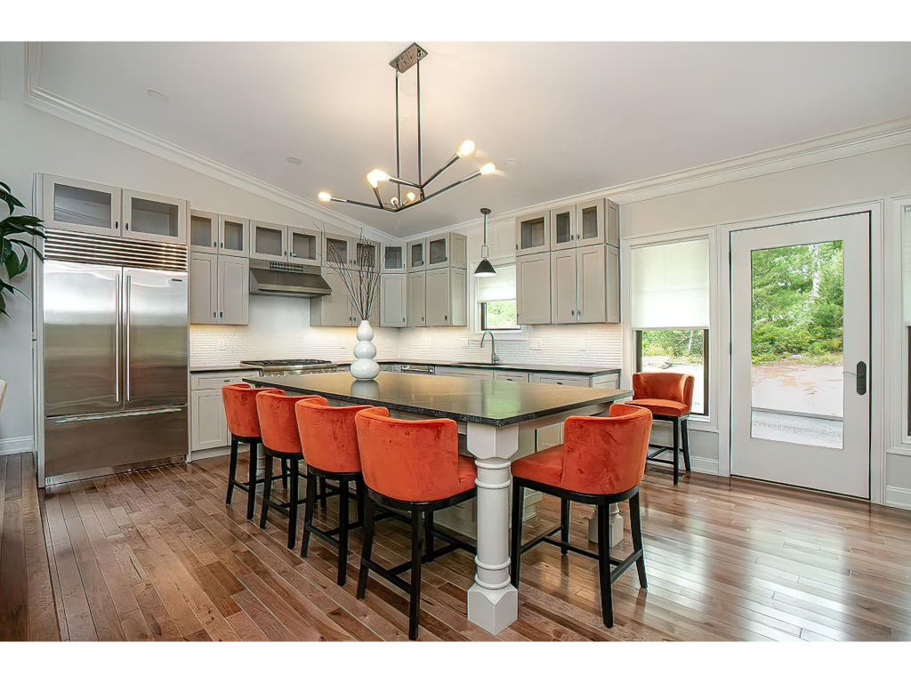 image Spacious and modern kitchen with ample natural light, high-end finishes, and an inviting ambiance for culinary delights.