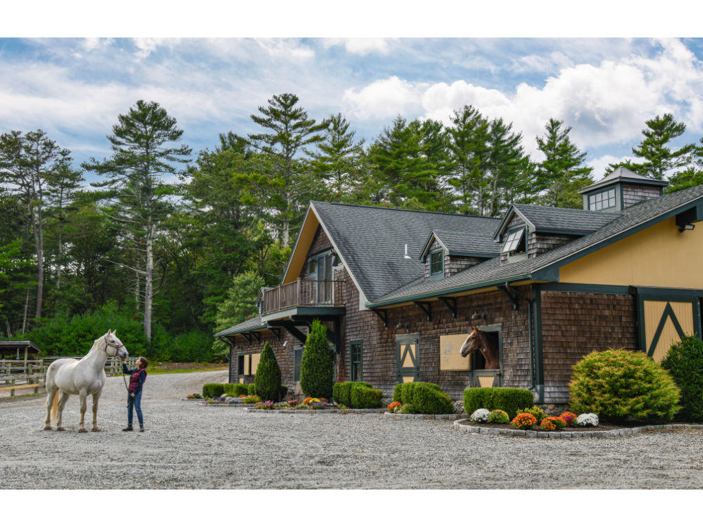 image Charming exterior view of the Equestrian Center House, surrounded by beautiful landscapes and horse facilities.