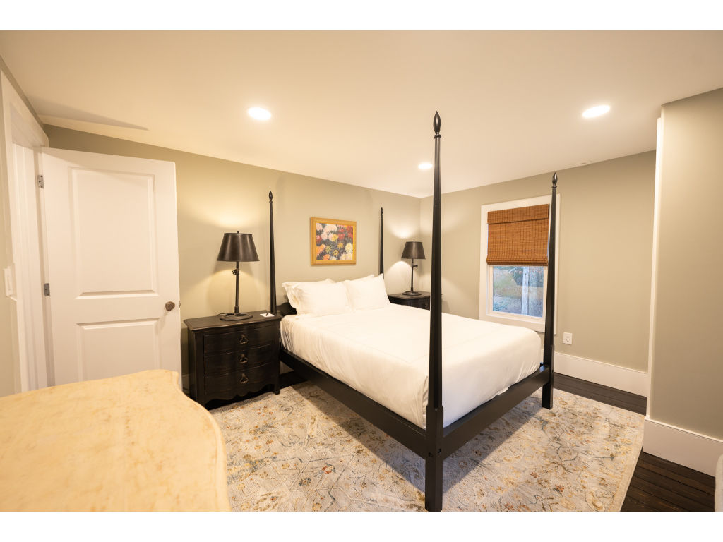 image Relax in this inviting bedroom featuring a classic four-poster bed and warm, soothing decor.