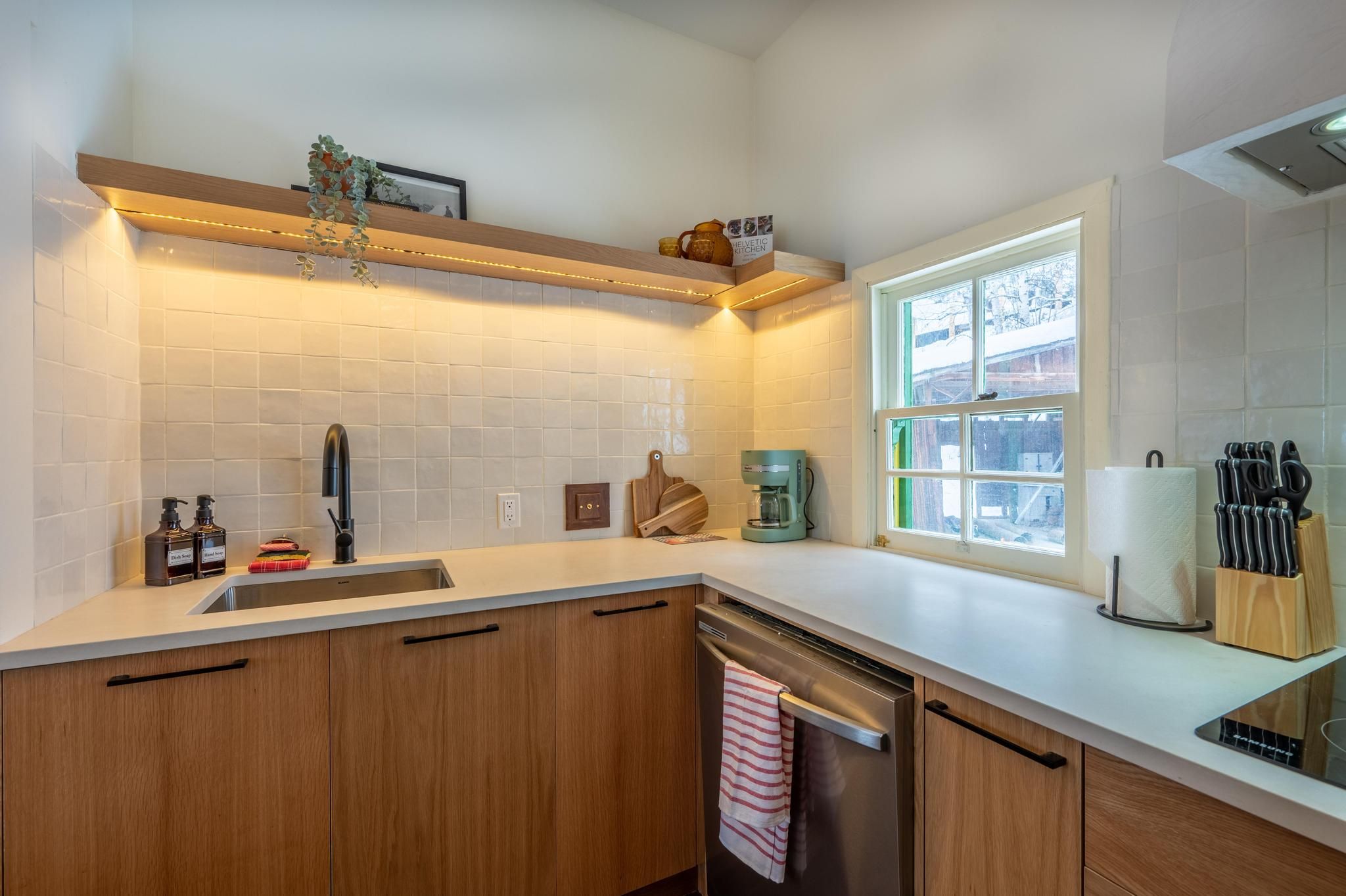 image "Fully equipped kitchen with modern cabinetry, sleek countertops, and all essentials for preparing meals (stovetop included, no oven).