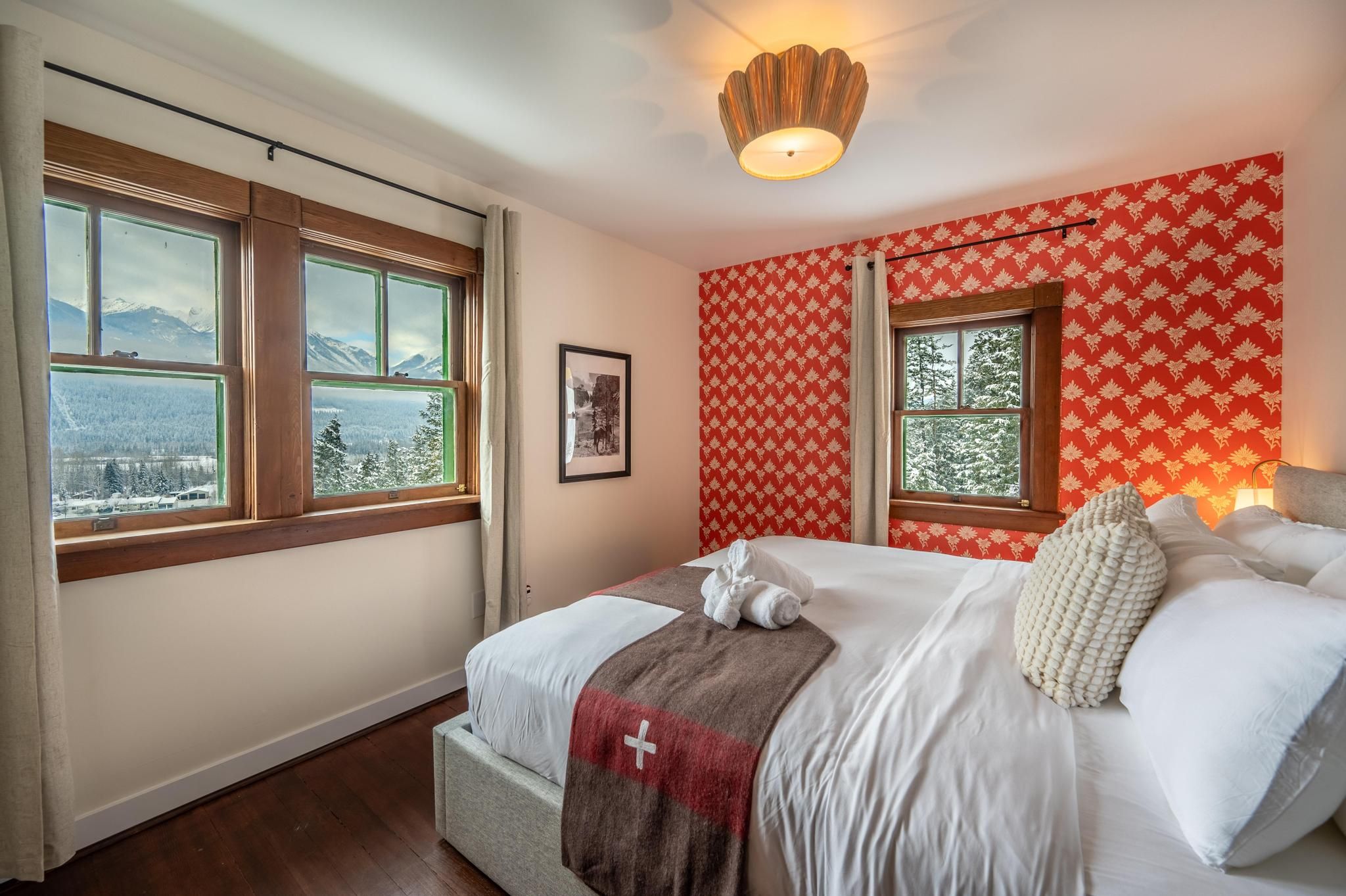 image Spacious primary bedroom with a king-sized bed, soft lighting, and wooden details for a restful retreat.