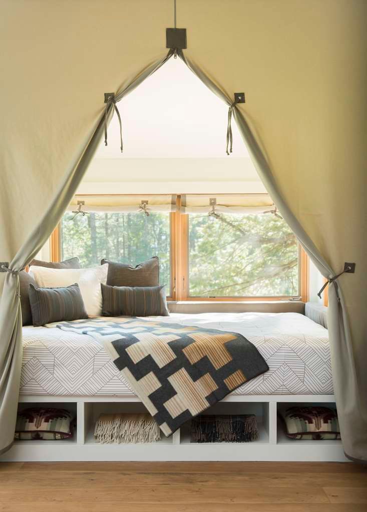 image Enjoy a restful night in this quaint and charming bedroom with beautiful natural light and rustic elegance.