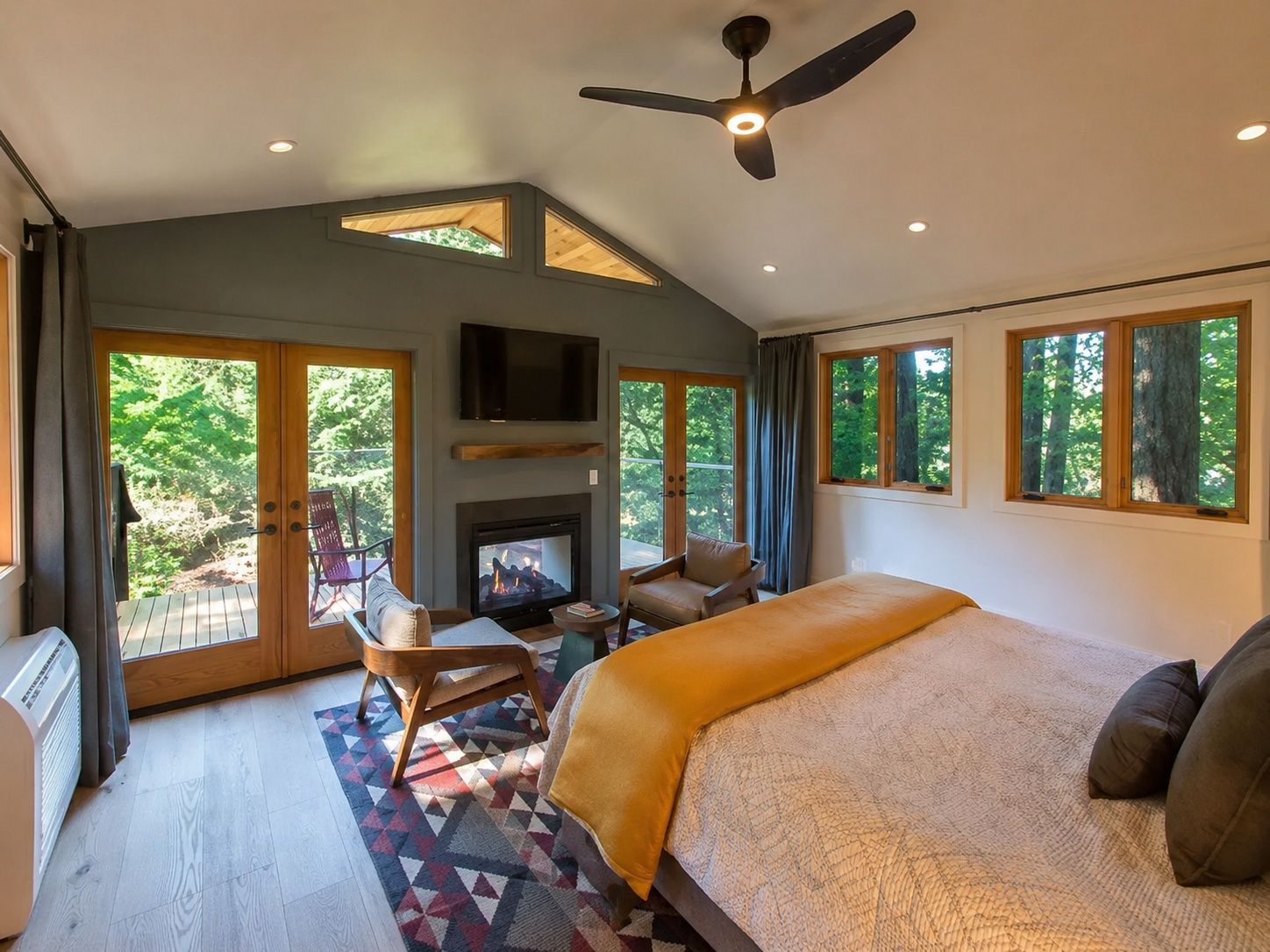 image Unwind in a spacious, sunlit bedroom with modern amenities and a cozy atmosphere.
