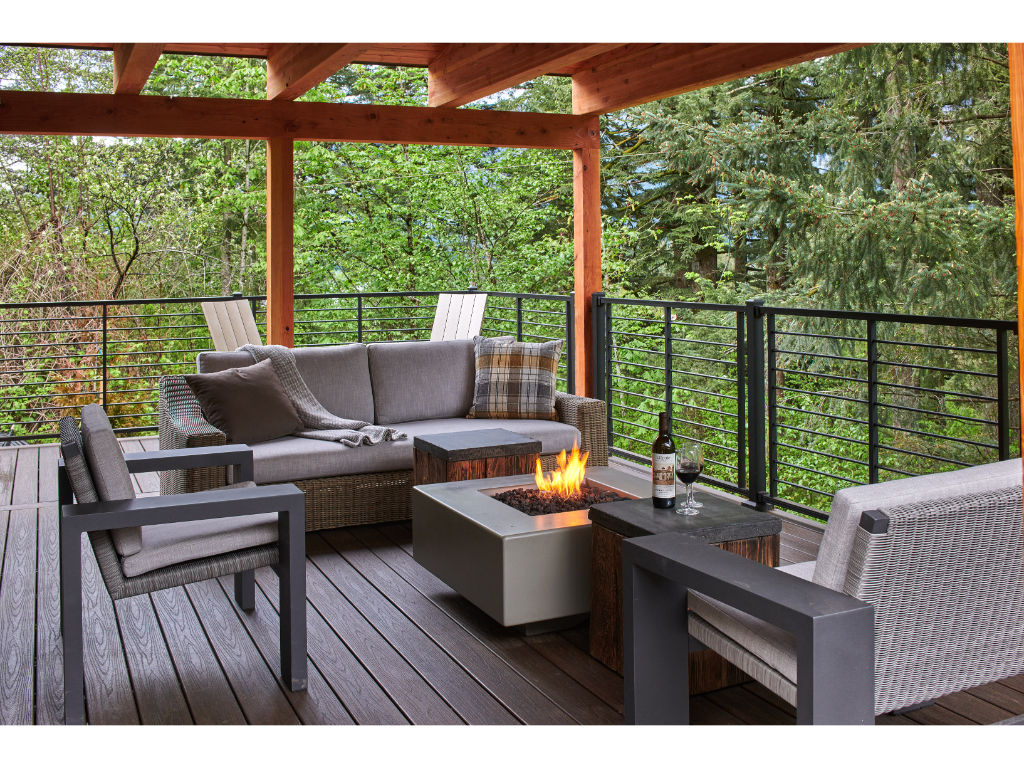 image Relax on the expansive deck with stylish outdoor furniture and stunning forest views.