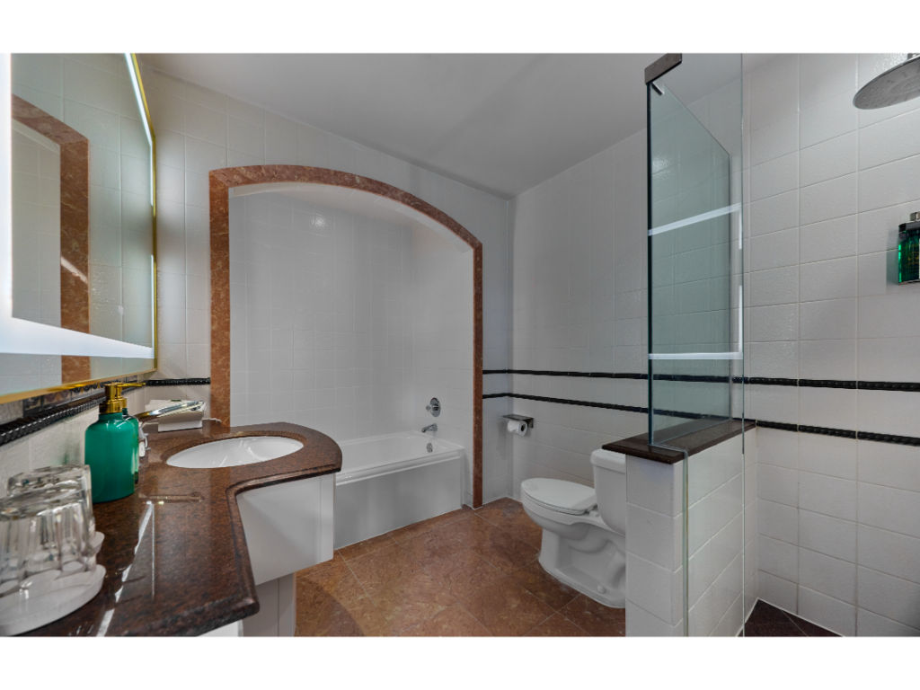 image Modern bathroom with a walk-in shower and refined finishes.