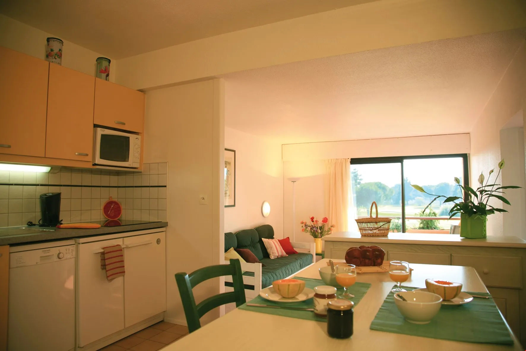 image Prepare meals in the small kitchen and enjoy them at the dining table.