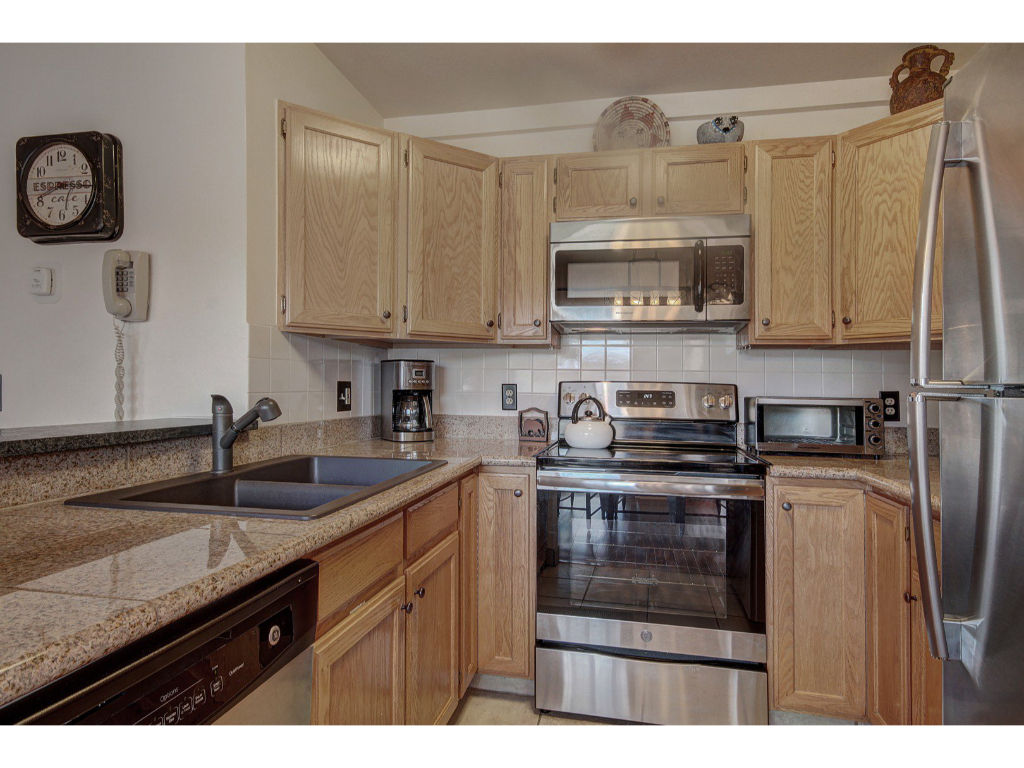 image Stylish kitchen with stainless steel appliances and plenty of counter space for meal preparation.