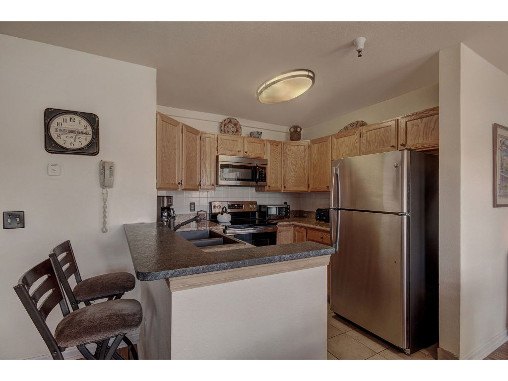 image Well-equipped kitchen with modern appliances and a convenient breakfast bar for casual dining.