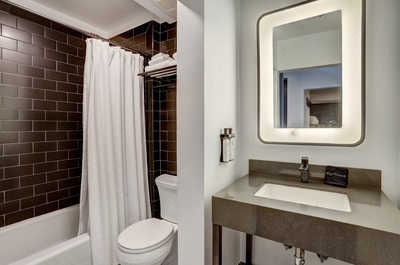 Sleek and modern bathroom with elegant finishes, offering a refreshing retreat with a spa-like ambiance.