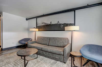 Thoughtfully designed seating area with warm lighting and contemporary furnishings, creating a cozy atmosphere.