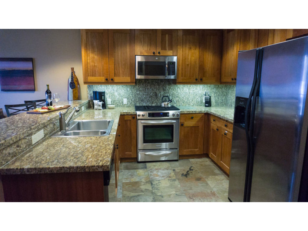 image Enjoy cooking in this spacious kitchen, complete with stainless steel appliances and granite countertops.