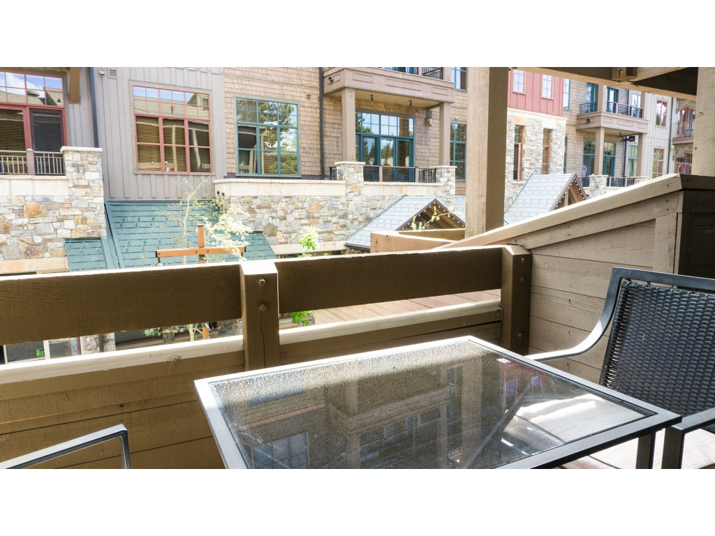 image Take in the views and fresh air from this private balcony, complete with comfortable outdoor seating.