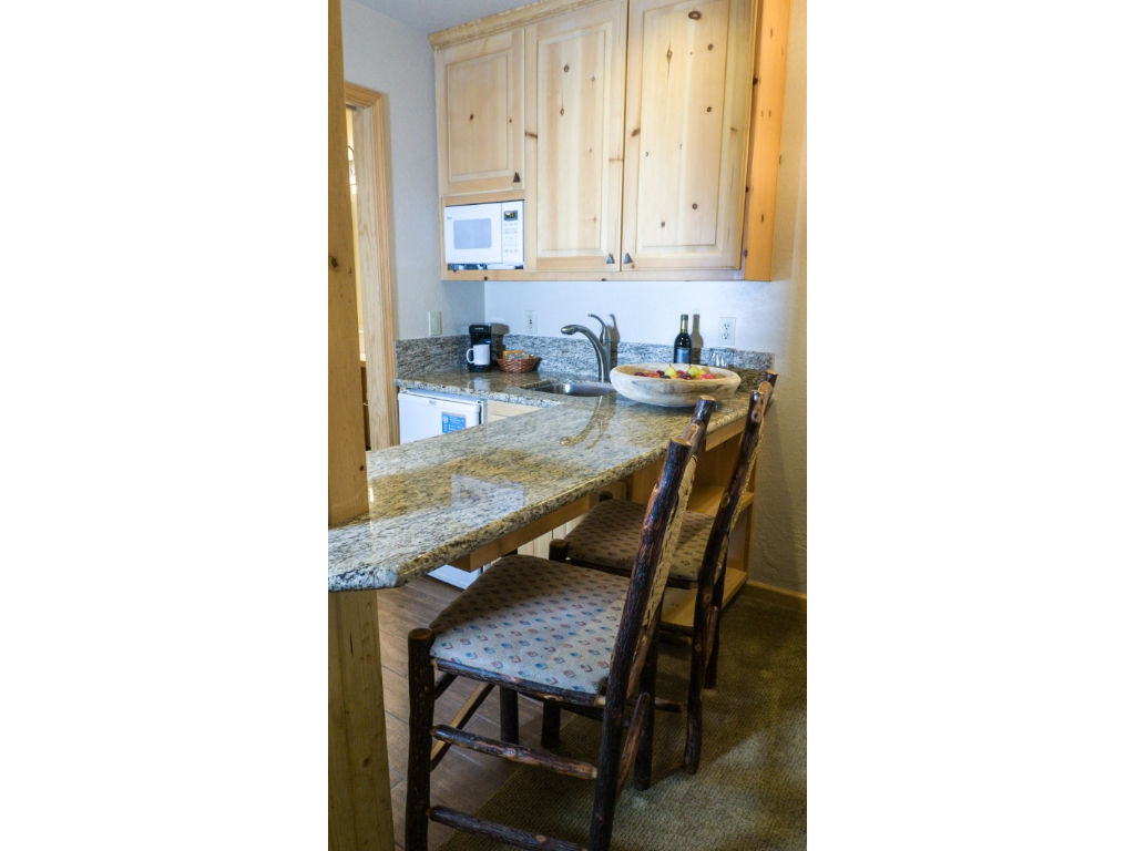 image This kitchen offers plenty of counter space and a convenient breakfast bar for casual dining.