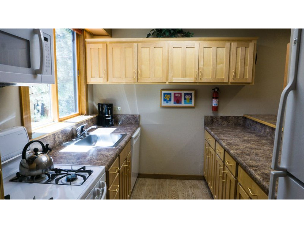 image Well-equipped kitchen with modern amenities, including a gas stove, microwave, and ample counter space.
