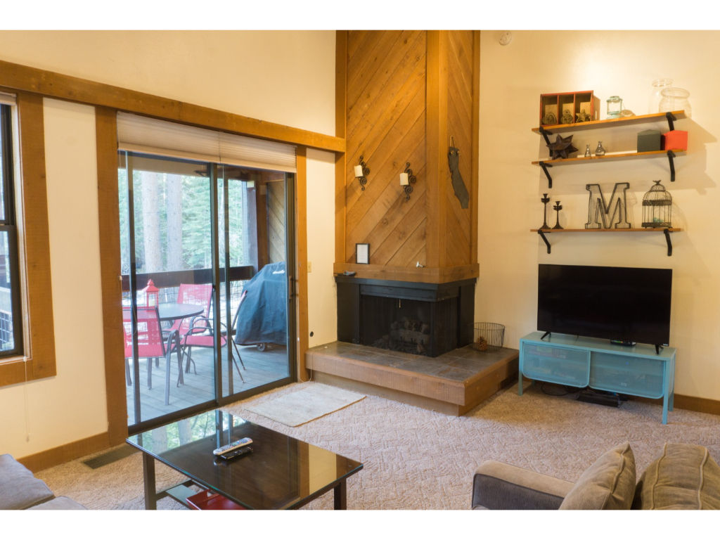 image Spacious living room with a welcoming fireplace, perfect for relaxing evenings, and large windows for natural light.