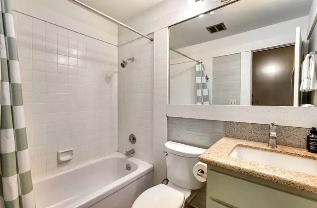 image Bright and clean bathroom featuring a full shower, modern fixtures, and fresh decor for a rejuvenating experience.