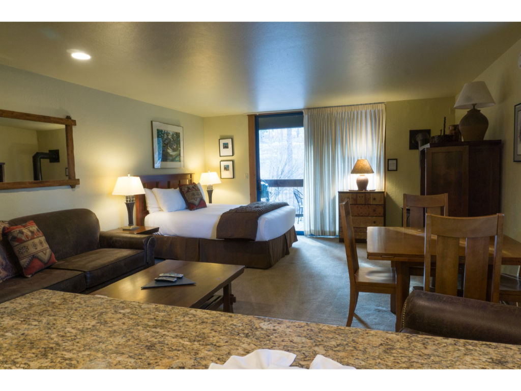 image Cozy living area with a large sofa, armchairs, and a coffee table, ideal for relaxing and socializing.