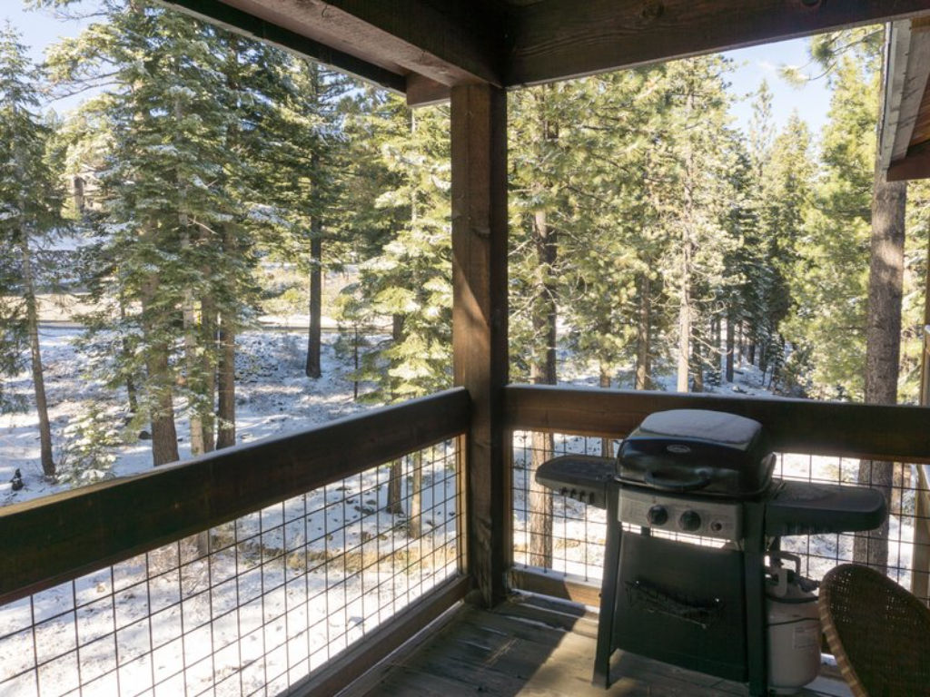 image Savor the beautiful forest views from the scenic balcony, perfect for grilling and outdoor dining.