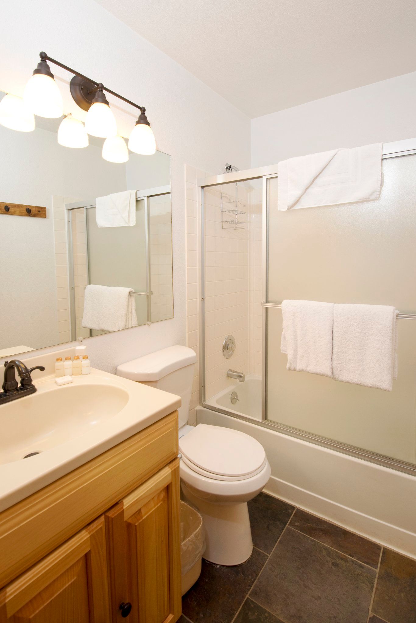 image Relax in a bright bathroom featuring a spacious shower and modern lighting for your personal retreat.