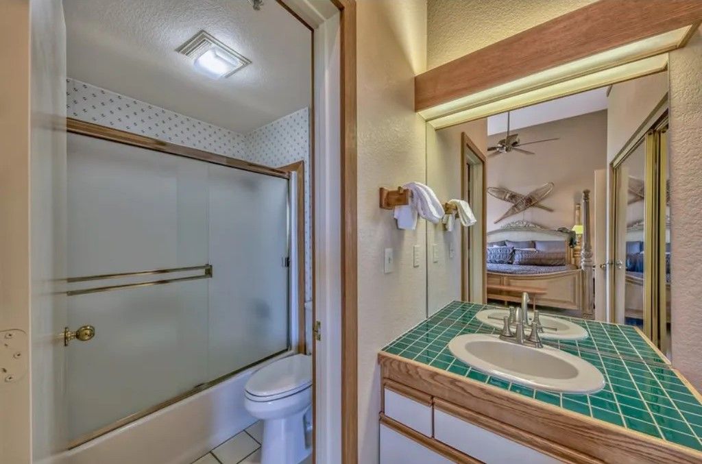 image Refresh in this second bathroom featuring a convenient walk-in shower, large vanity, and bright lighting.