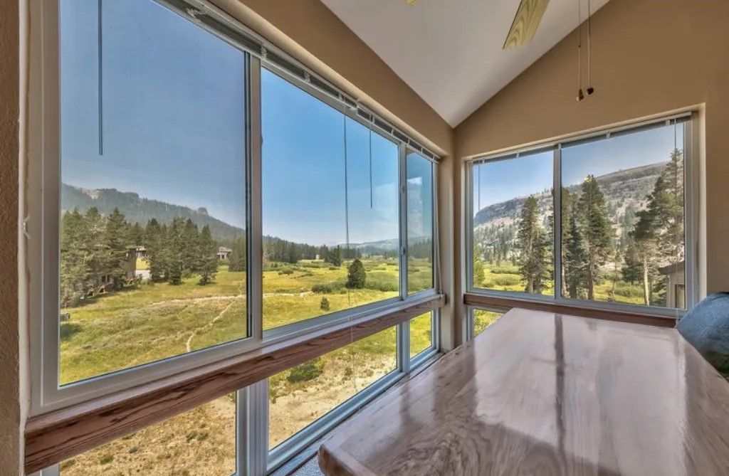 image Enjoy the sunshine in this bright sitting area with expansive windows offering breathtaking views of the natural surroundings.