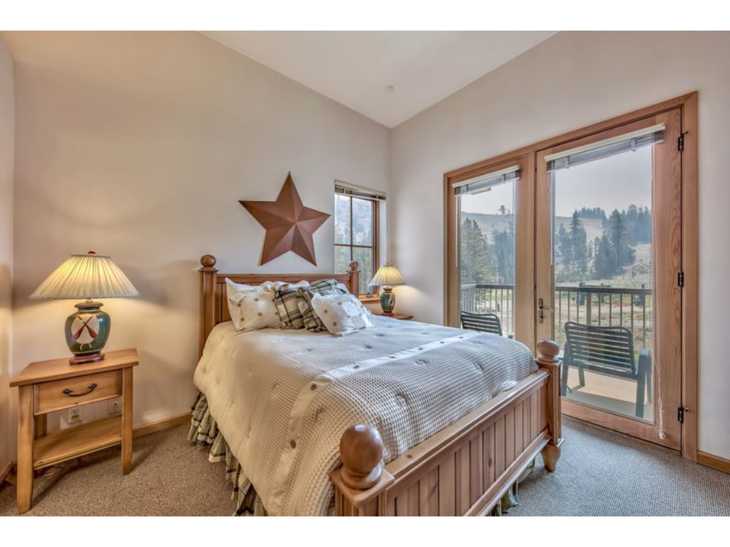 image Wake up to breathtaking views from this charming bedroom featuring a comfortable queen bed and rustic decor.