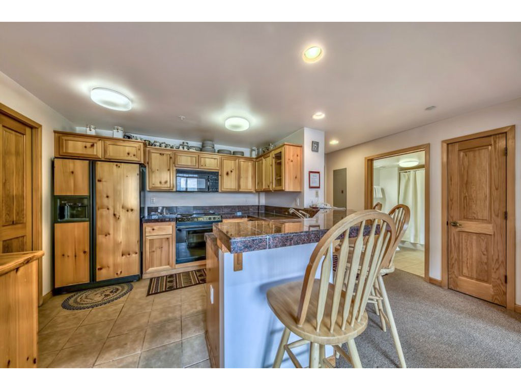 image Cook up a storm in this fully equipped kitchen with modern appliances, ample counter space, and a breakfast bar for casual dining.
