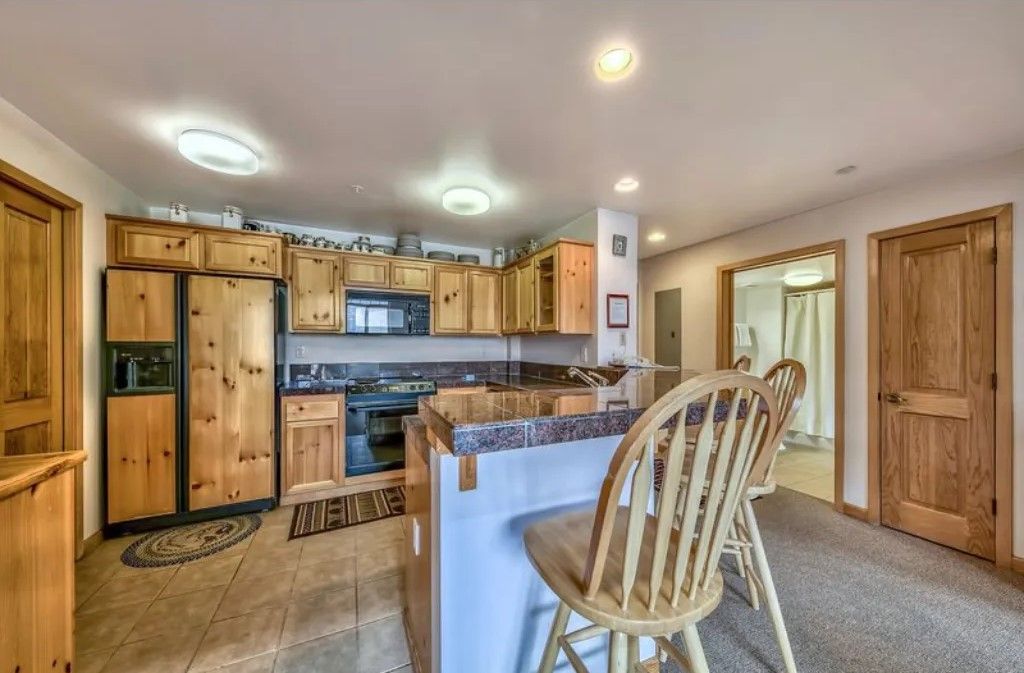 image Cook up a storm in this fully equipped kitchen with modern appliances, ample counter space, and a breakfast bar for casual dining.