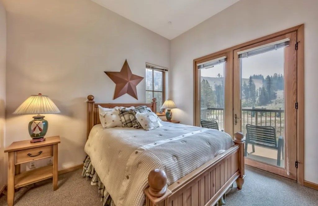 image Wake up to breathtaking views from this charming bedroom featuring a comfortable queen bed and rustic decor.