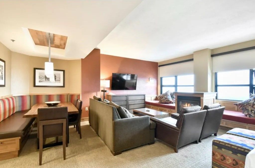 image Spacious living and dining area with modern furnishings and large windows.