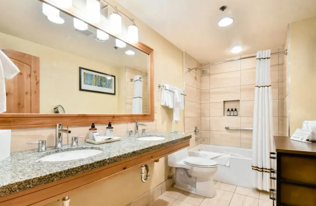 image Luxurious bathroom with double vanity and a relaxing tub.