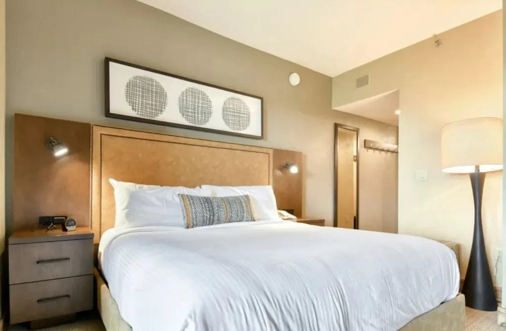 image Comfortable bedroom with a king-size bed and ambient lighting.