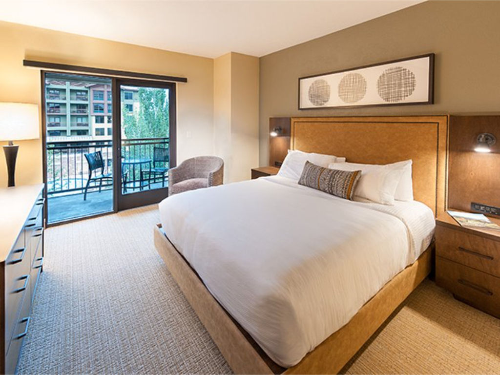 image Cozy bedroom with natural light and a plush queen bed.