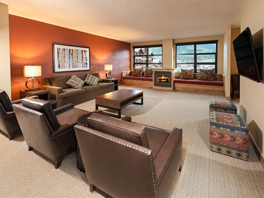 image Spacious living room with modern decor and large windows.