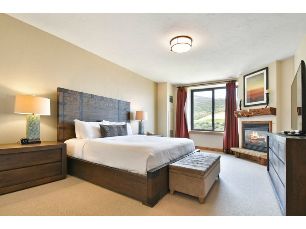 image Modern bedroom with a king bed and natural light.