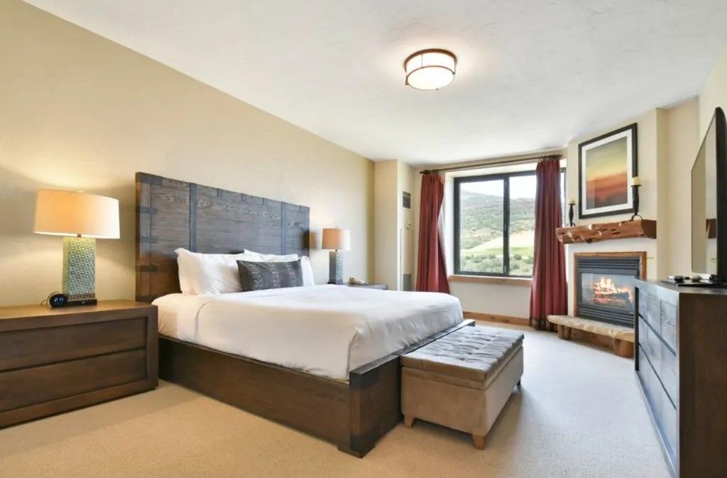 image Modern bedroom with a king bed and natural light.