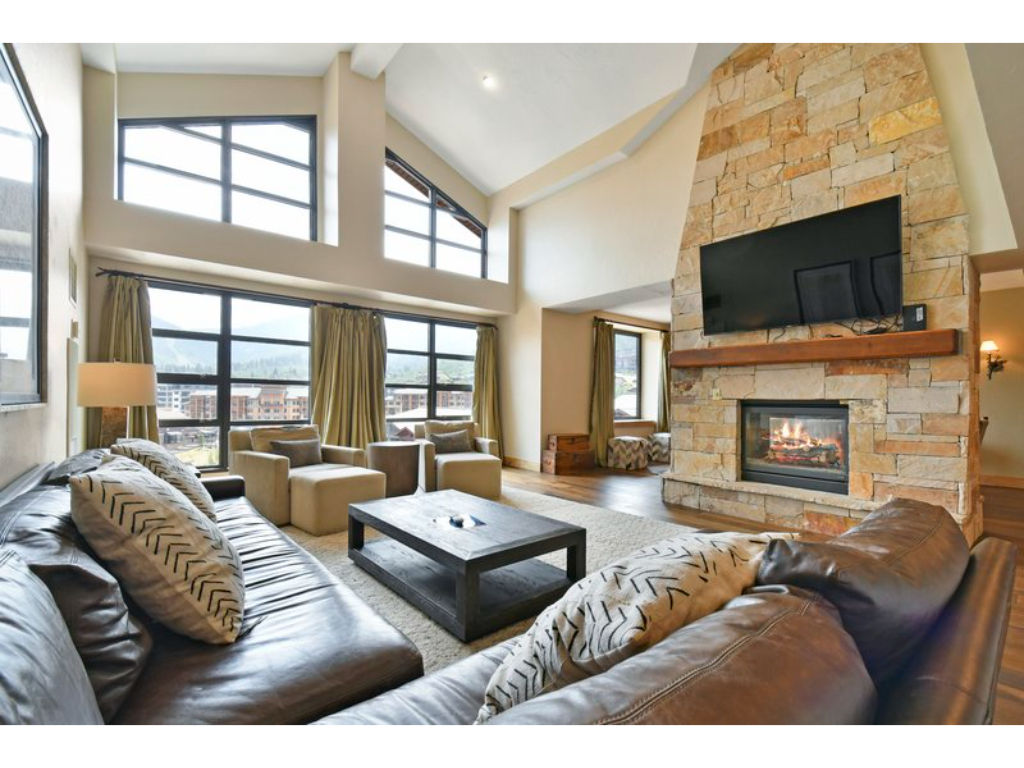 image Cozy living room with a stone fireplace and plush seating.