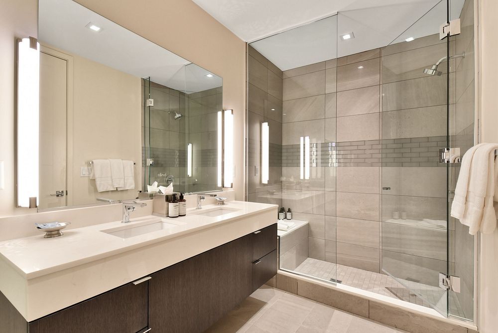 image Modern bathroom featuring a walk-in shower and sleek design.