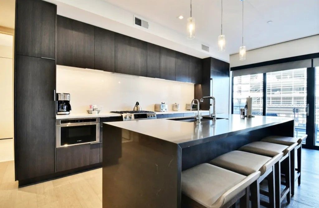 image Modern kitchen with a large island and sleek design.