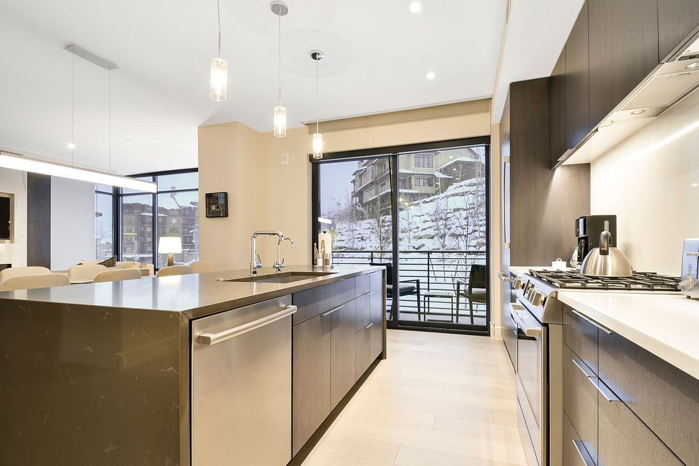 image The gourmet kitchen features state-of-the-art appliances, a stylish island, and easy access to a private balcony, making it ideal for both cooking and enjoying the crisp mountain air.