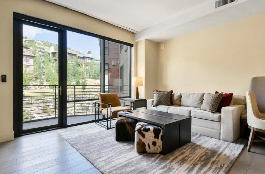 image Bright living area with large windows and stylish decor.