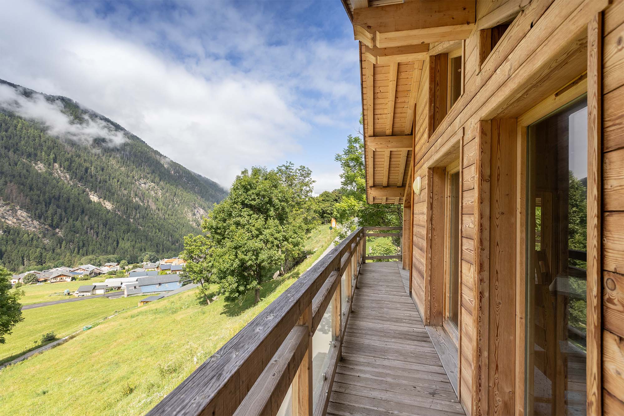 image Step out onto the spacious wooden balcony and take in the breathtaking views of the surrounding mountains.